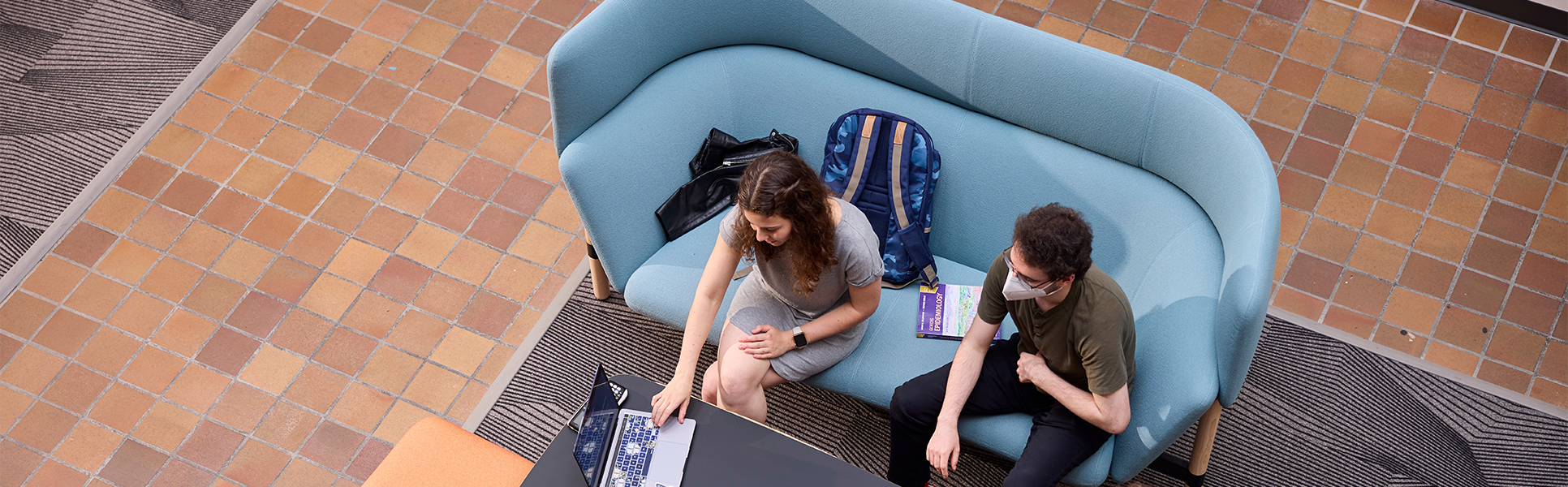 Students working together on a laptop.