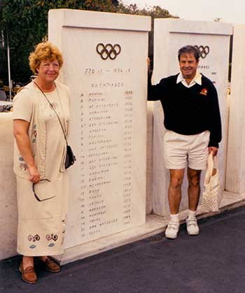 Phyllis and Leo Khan in front of olympics monument